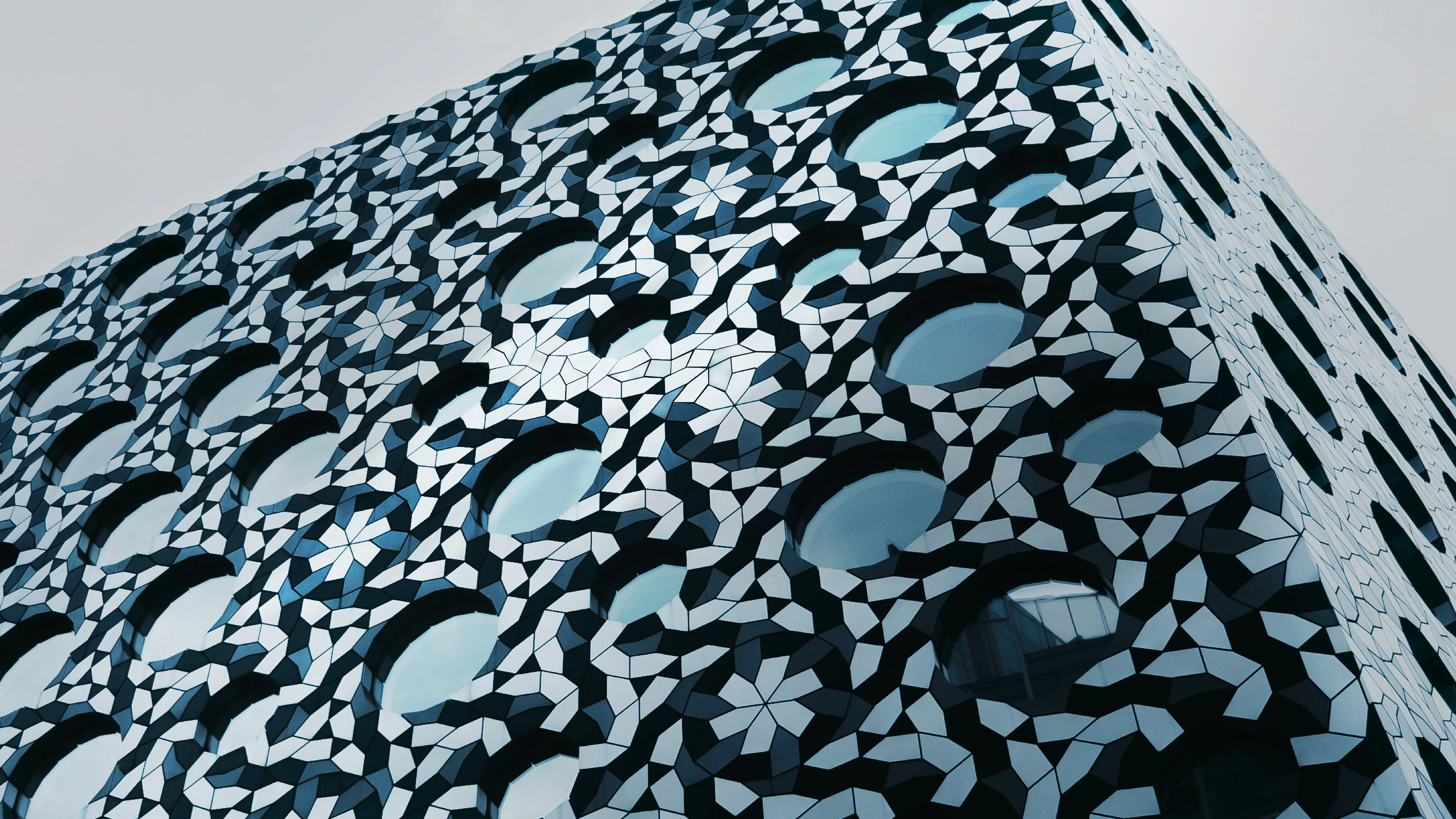 Building with abstract mosaic facade and round windows